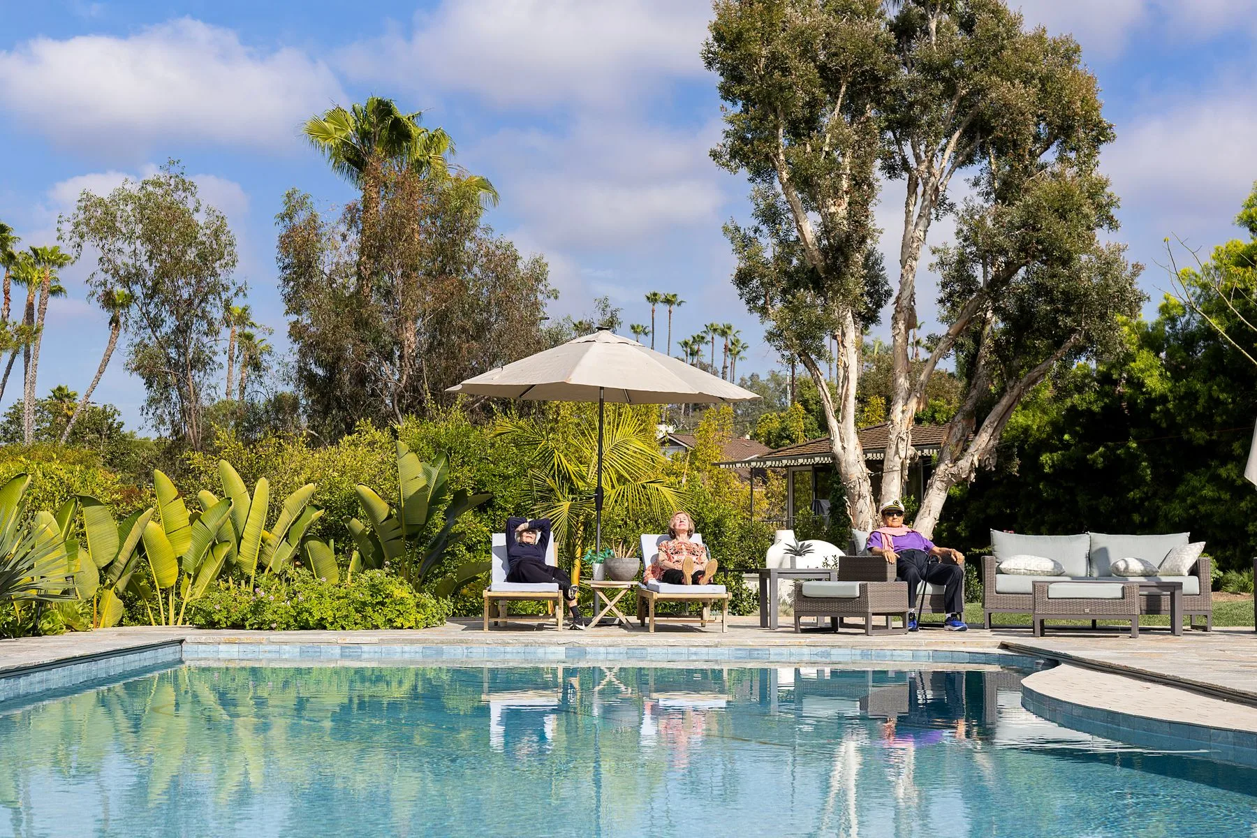 Residents relaxing by the pool at Casa La Granada